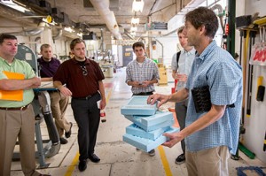 Design Shop Manager Mark Shumake shows examples of models that the college's new CNC mill can create, using a subtractive process on materials such as wood, Styrofoam, metals, and plastics.Photo by Eddy Perez, LSU University Relations