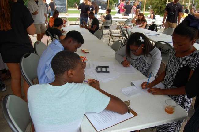 Residents and members of churches adjacent to the project site filled out surveys and chatted with students at Mid City Speaks.