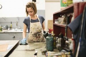 Female student at work in smock