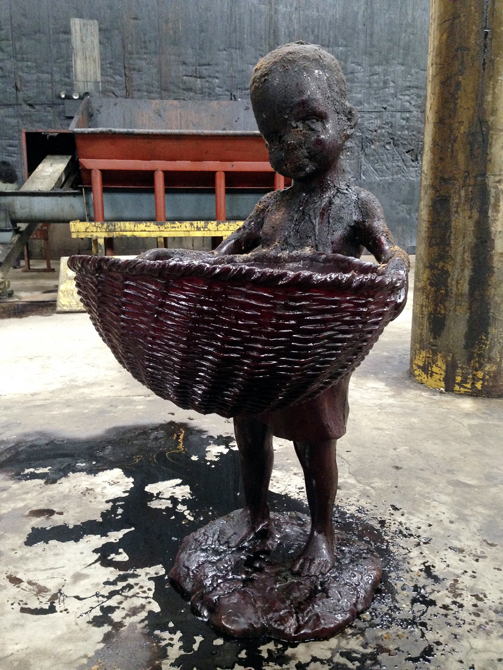 Sculpture of child holding basket