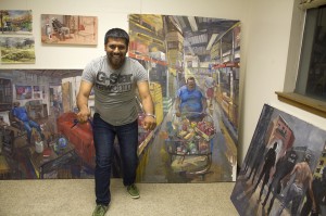 Student smiling in front of paintings