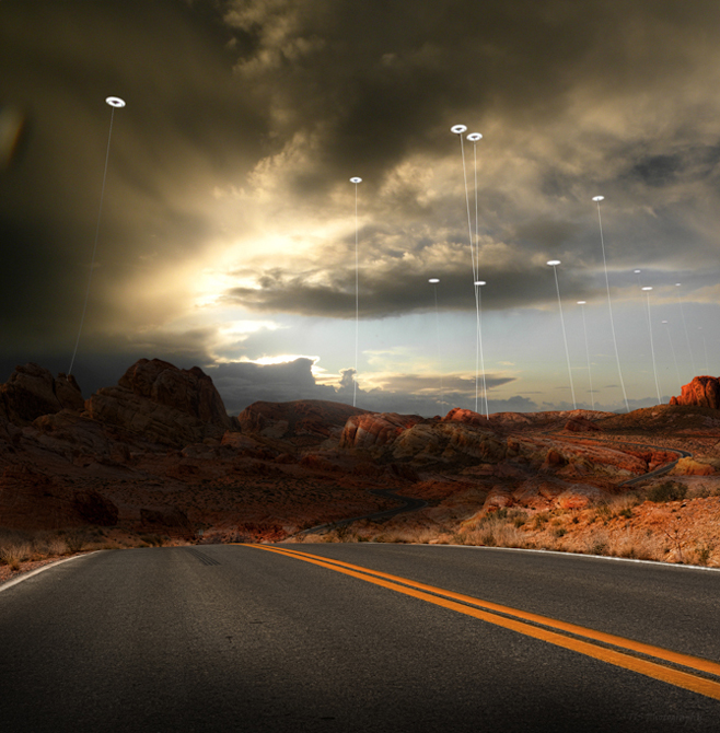 Image of road with southwestern desert terrain, sky