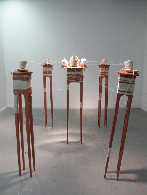 Teacups on large wood clothspins wrapped in yarn.Mallory Feltz LSU MFA Thesis