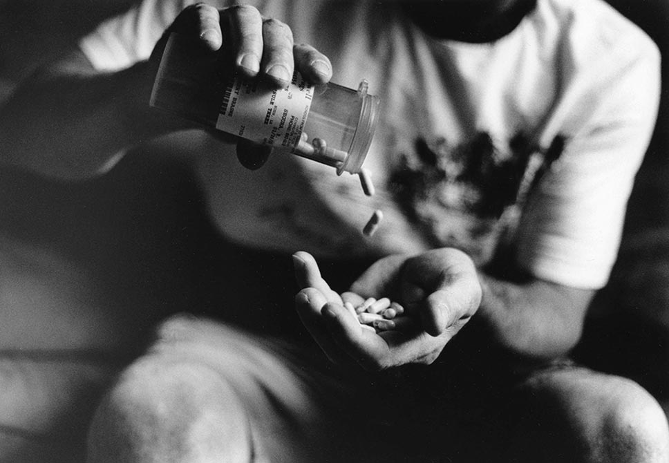 hands pouring pills out of bottle, lsu intermediate photography