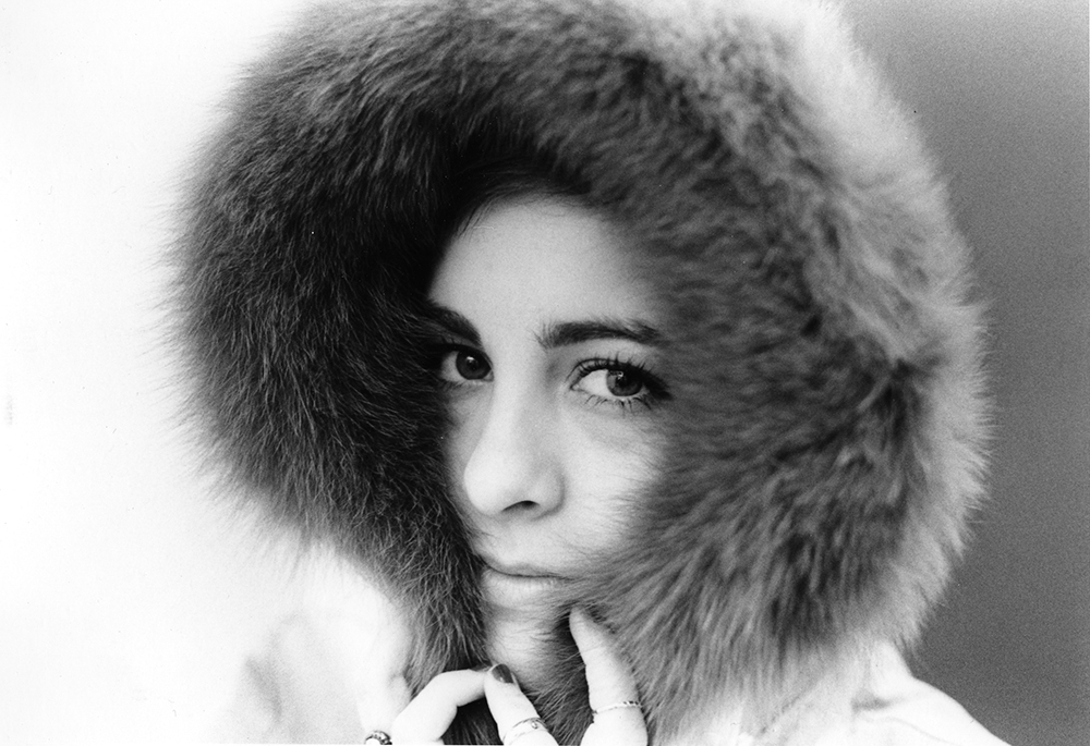 photograph of closeup of woman in fur hood