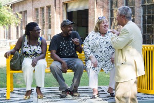 nadine carter russell and nari ward laughing on bench