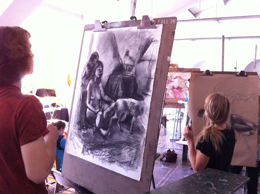 lsu art 4889 advanced figure drawing students work on charcoal drawings at easels