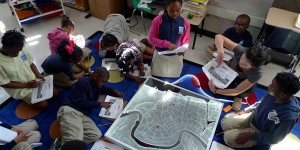 Students working with elementary school children in a classroom