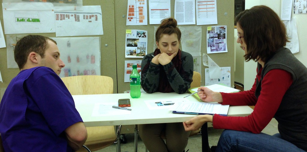 People in discussion at table.