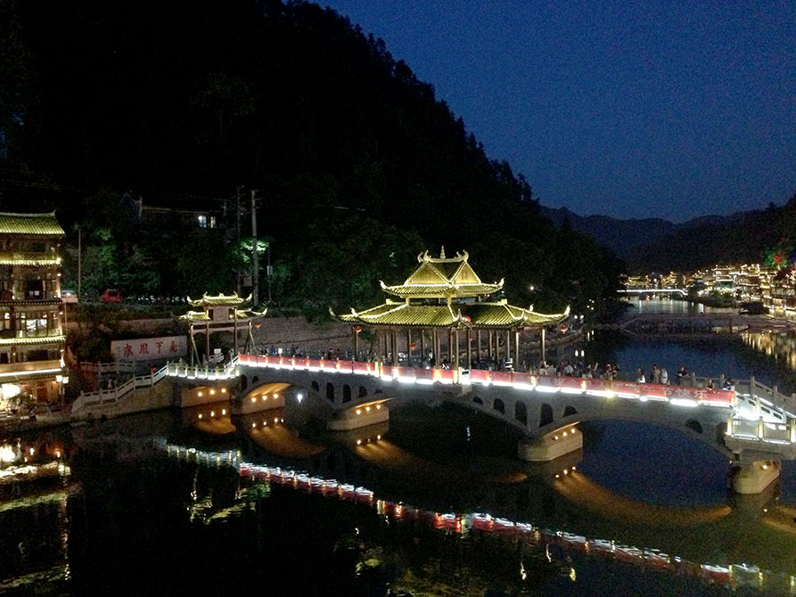 Glowing building and bridge at night