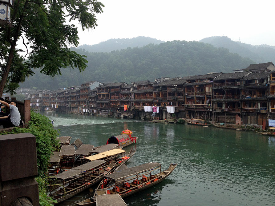 Boats along river, mountains in background