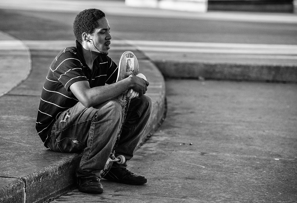 Skater sits listening to music