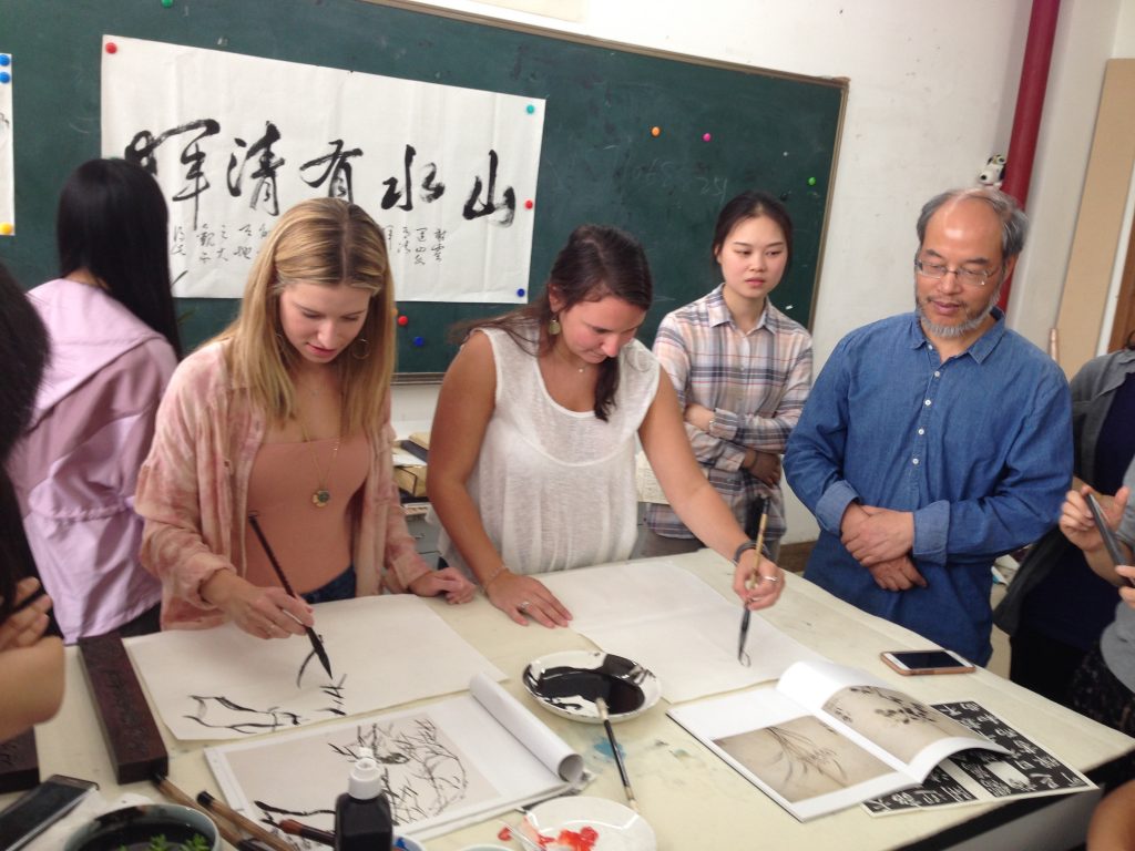 Practicing traditional Chinese painting and calligraphy.