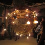 Young people stand in dimly lit room