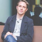 Portrait of Anthony Acciavatti sitting with legs crossed