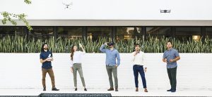 Members of CICADA team pose together in front of a white wall