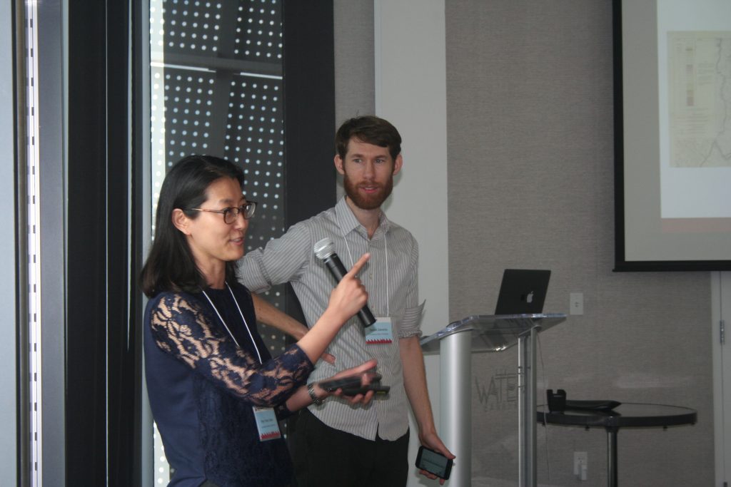 Woman giving presentation with microphone in hand