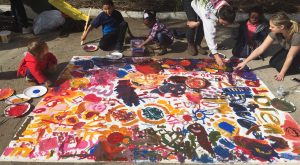 Students and kids paint bright colors