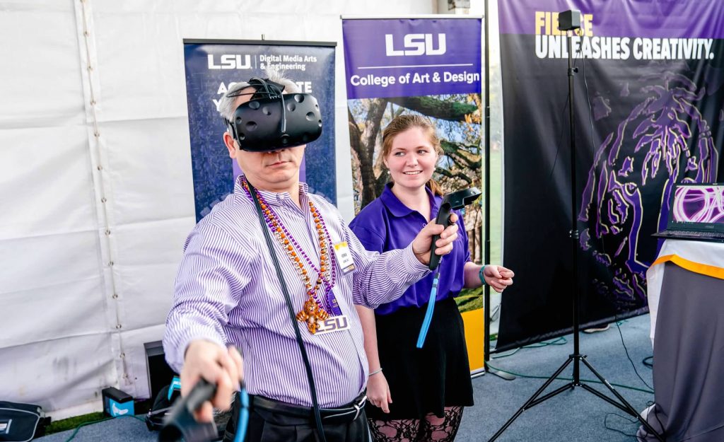 Female student smiles, man uses tech