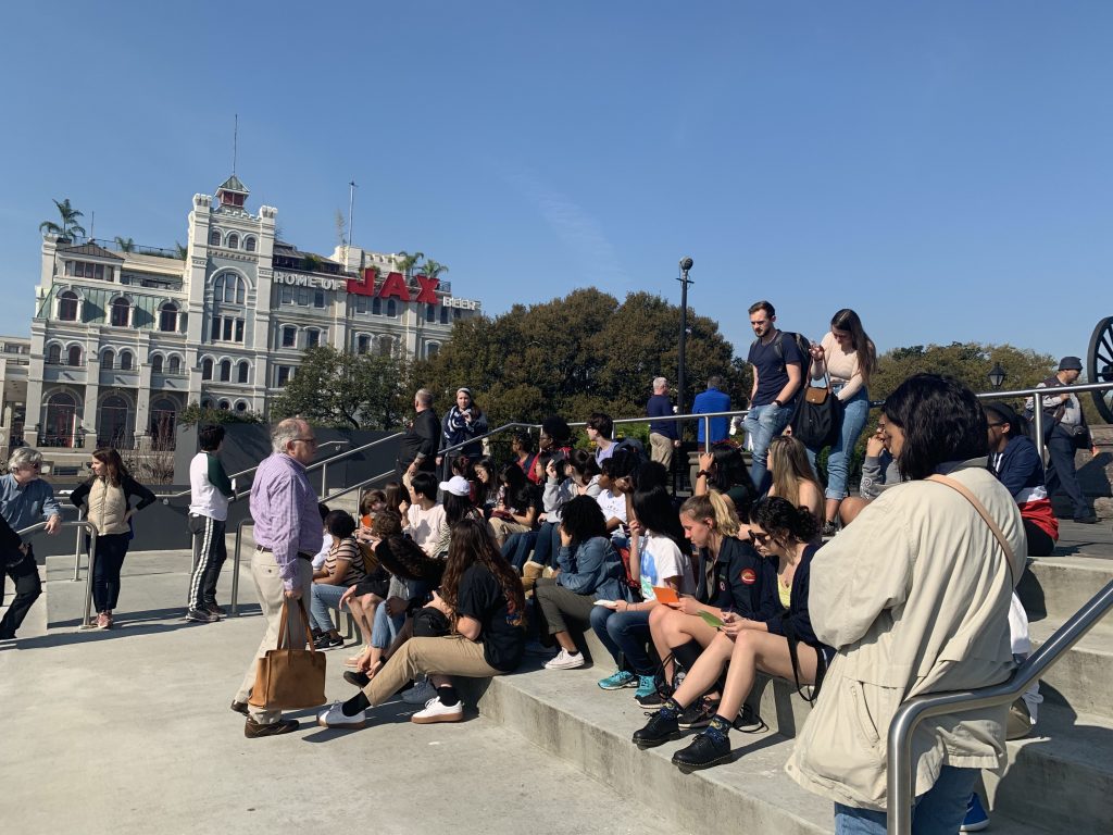 Students sitting on steps in French Quarter, New Orleans