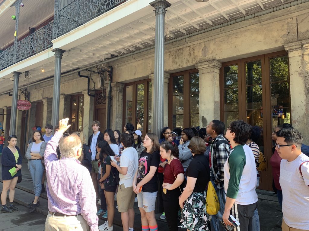 Group under balcony in downtown New Orleans