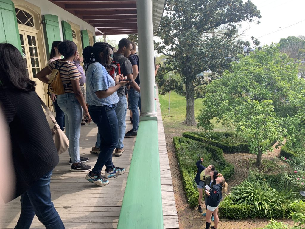 Students on balcony overlooking green garden