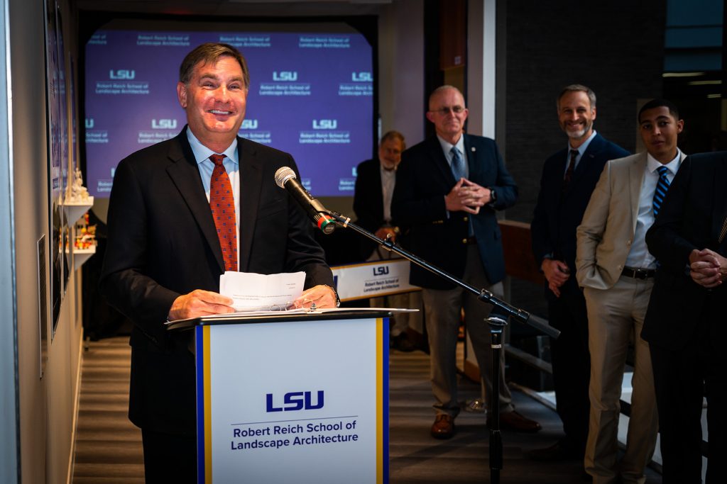 Man smiling at podium