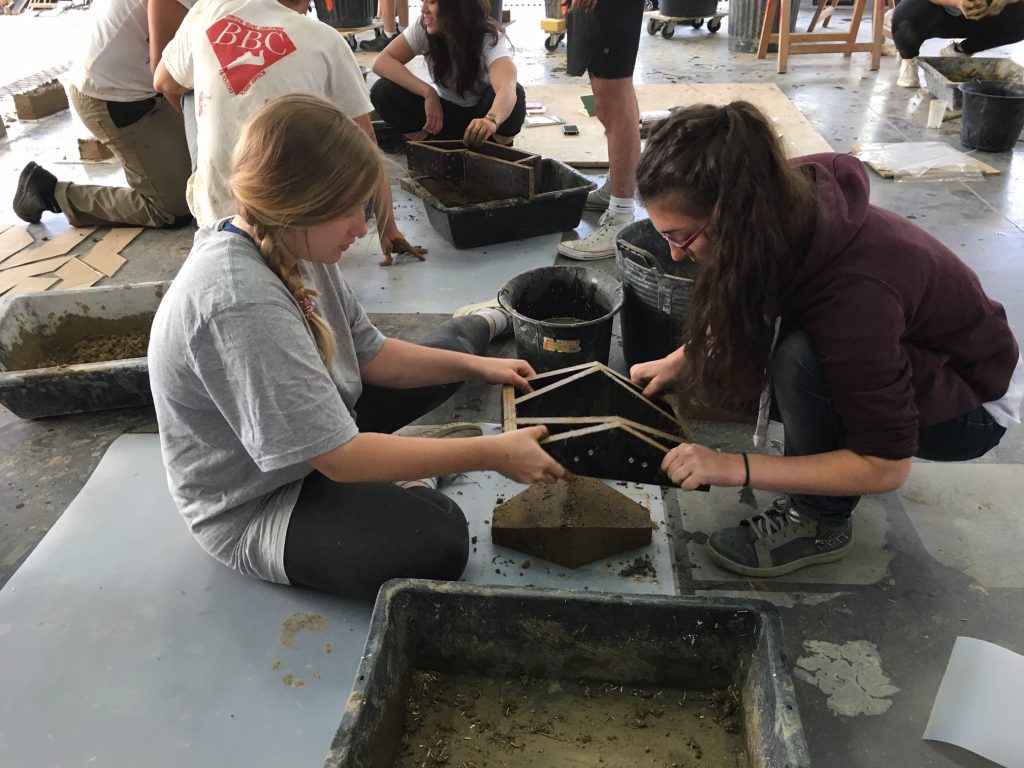 Two girls with brick mold