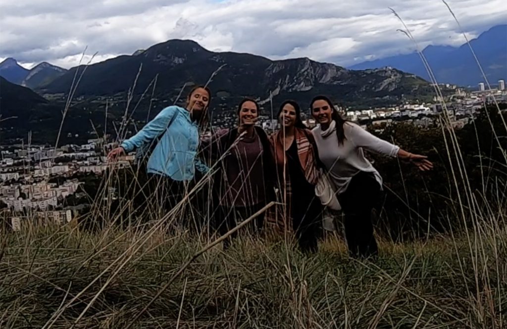 smiling girls, mountains in background