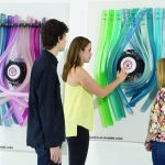 People observe colored art installation