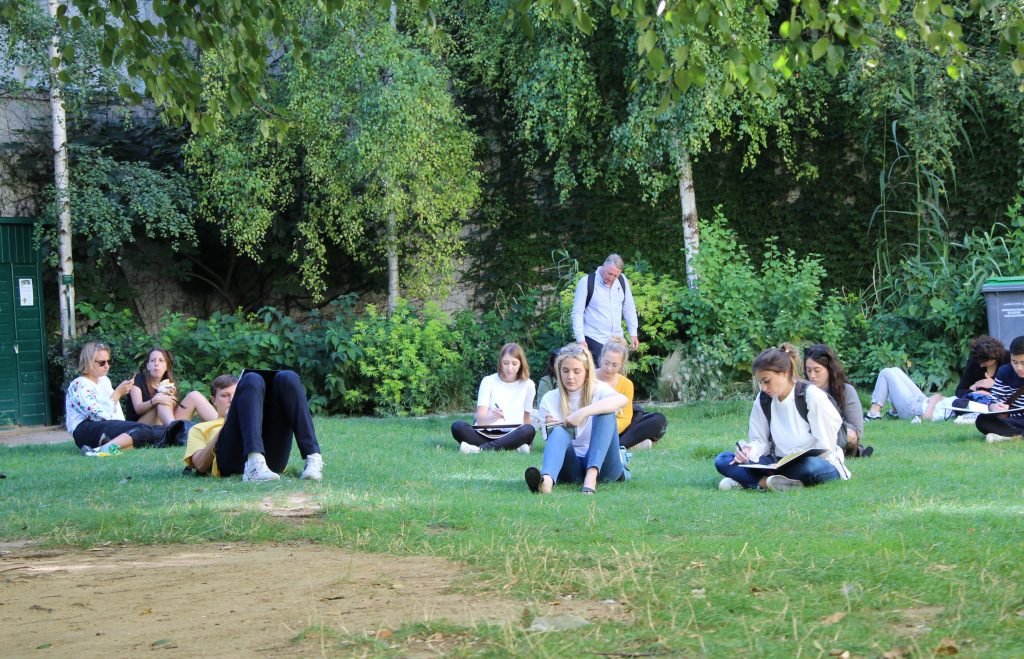 students drawing in park