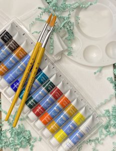 Paint brushes and colored paint tubes