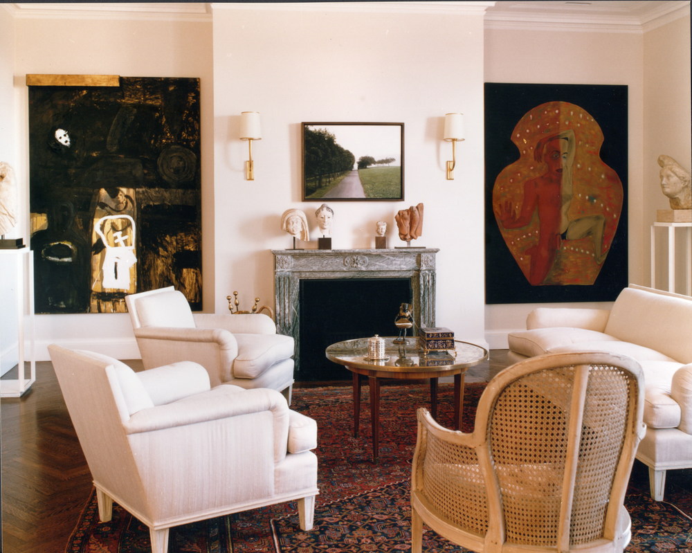 Room with fireplace, chairs, ornate rug, large wall art