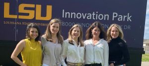 Women stand in front of LSU Innovation Park sign