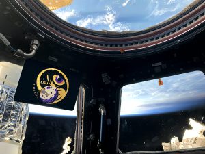 Tiger Eye 1 logo in space station, Earth in space out window