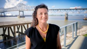 Traci Birch by Mississippi River, bridge in background