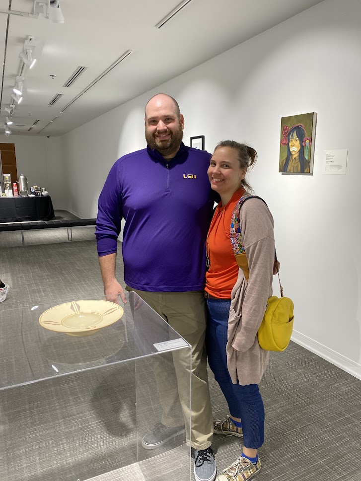 smiling man and woman by ceramic plate