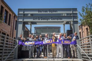 Purple LSU ribbon cut in front of Barnes Ogden building