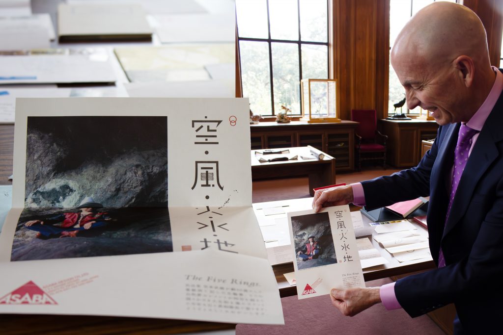 smiling man holding Asian print